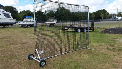A baseball field with a portable screen on it