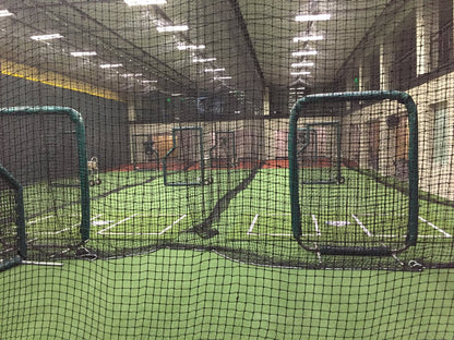 A view of batting cages in an indoor facility.