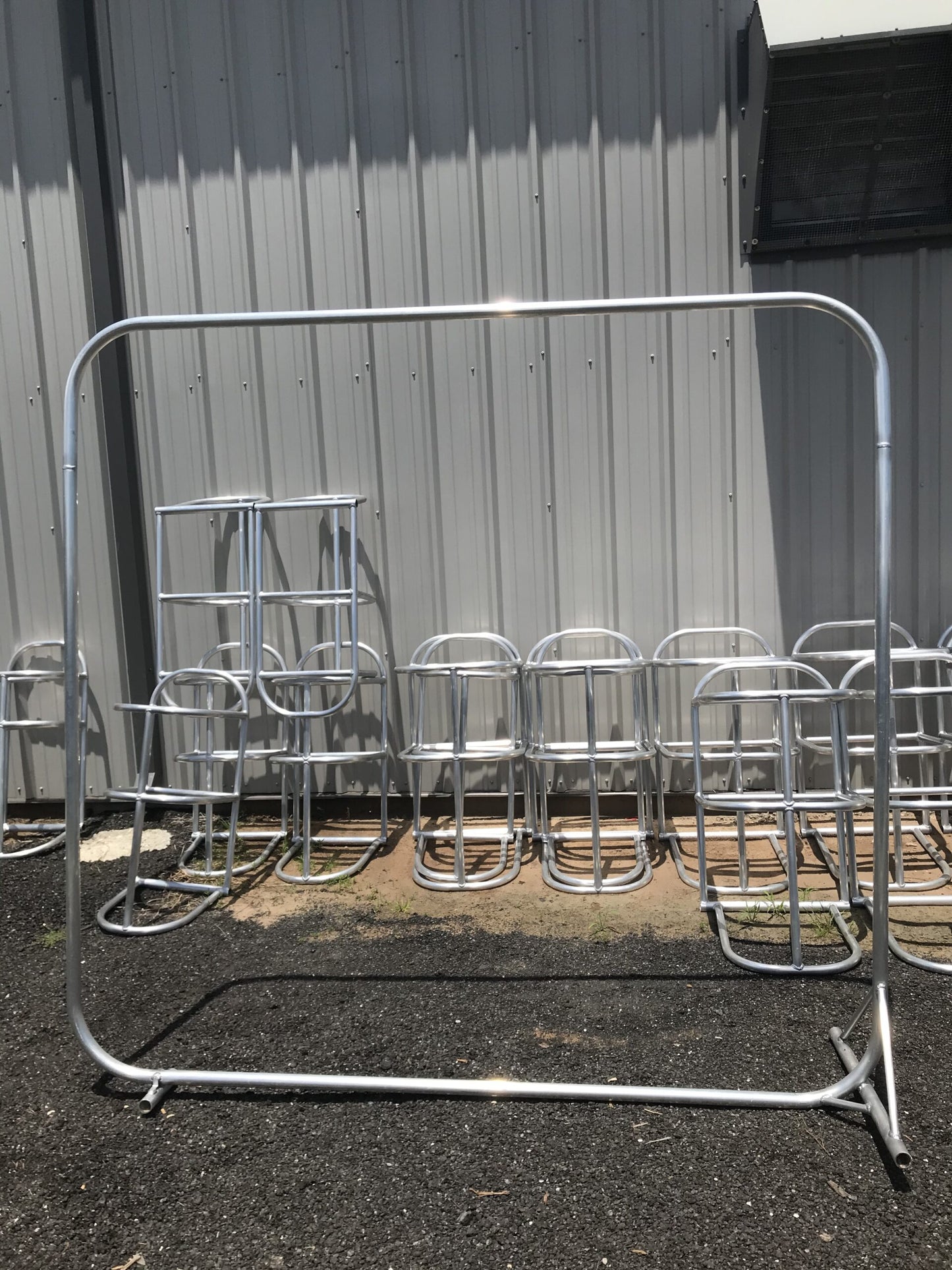 A bunch of metal chairs are lined up in a row.