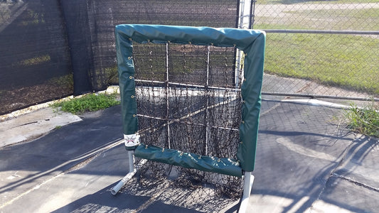 A baseball cage with a net on top of it.