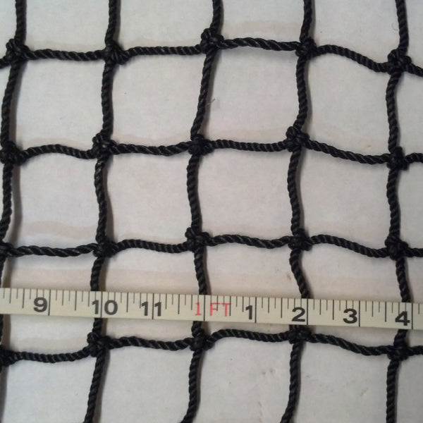 A white cloth with black netting and ruler