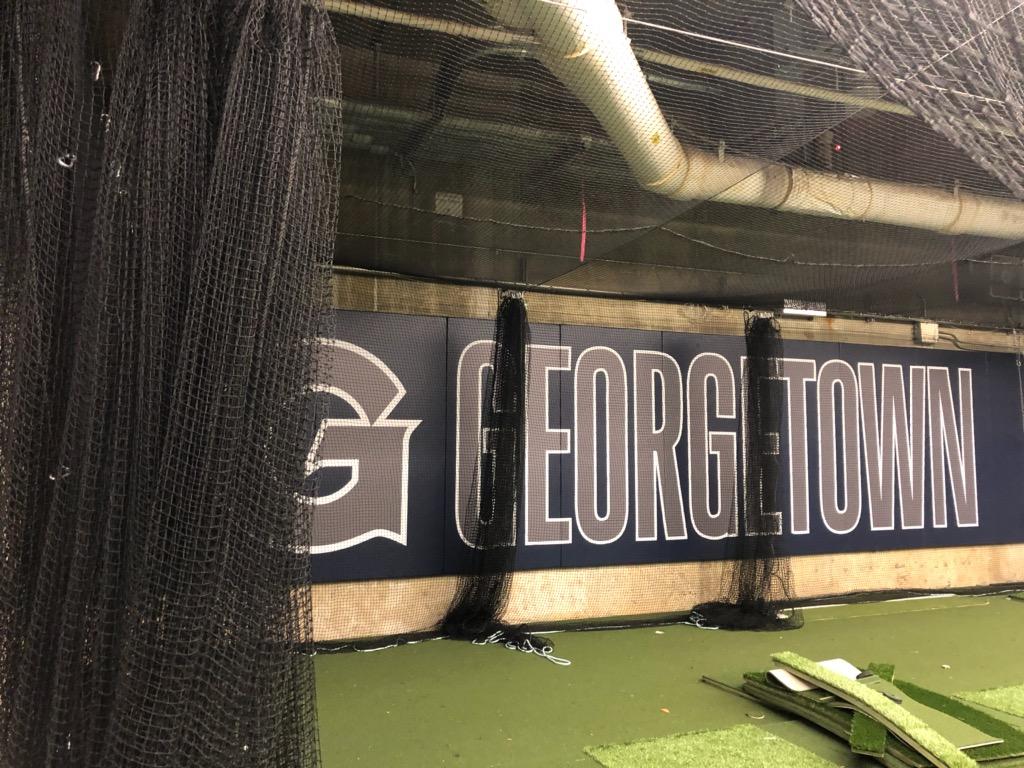 A baseball field with a batting cage and the name of george town.
