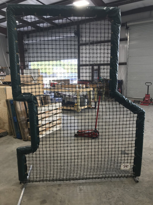 A cage in the middle of an indoor warehouse.