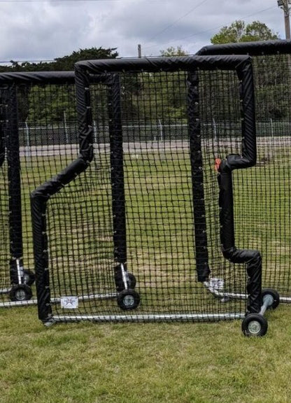 A pair of baseball catchers ' screens on wheels.