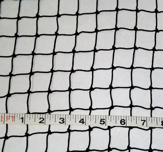 A white cloth with black netting and a ruler