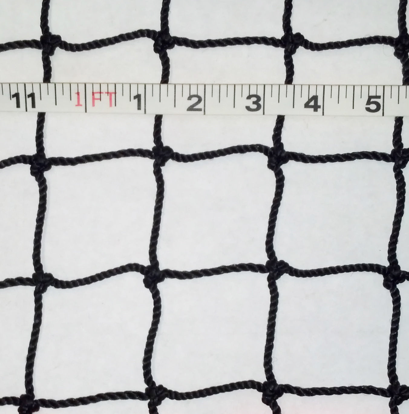 A white cloth with black netting and a ruler