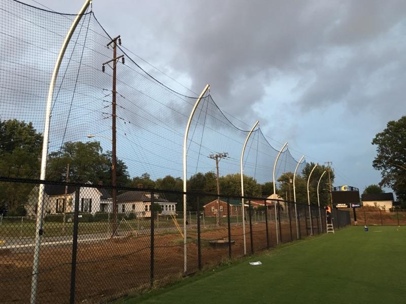 A field with a fence and power lines on it