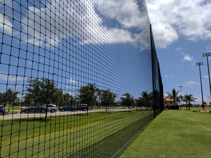 A view of a tennis court through the fence.