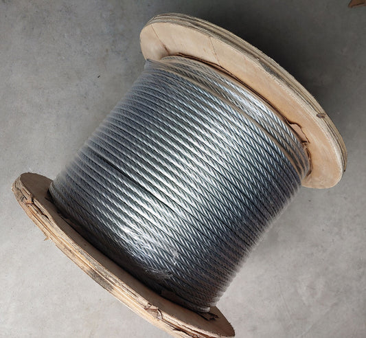 A spool of wire sitting on top of the floor.