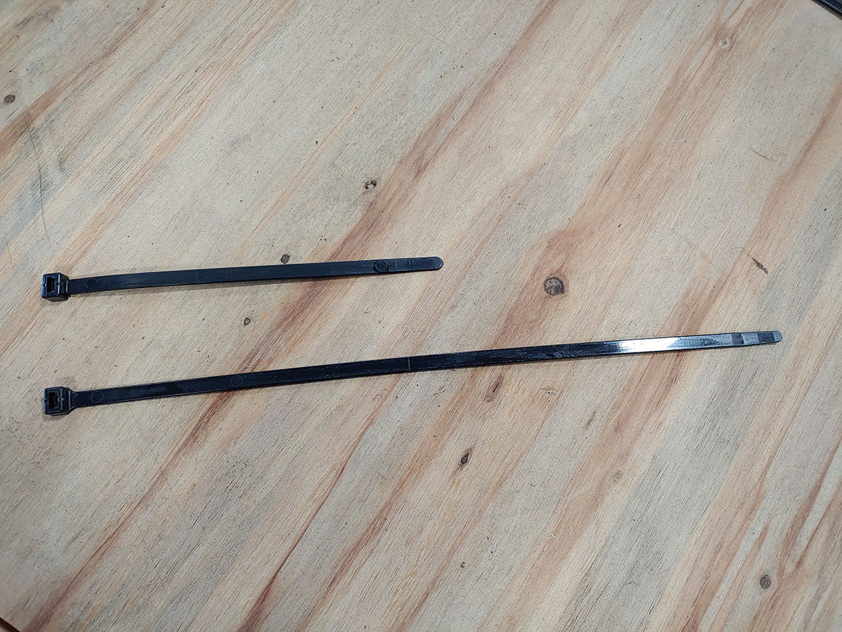 A pair of chopsticks on top of a wooden table.