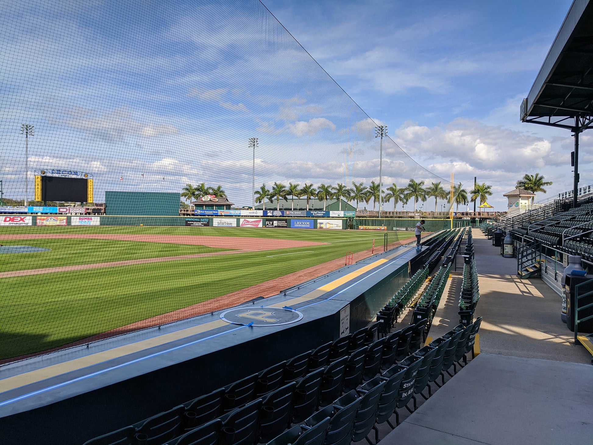 A baseball field with a green grass covered field.