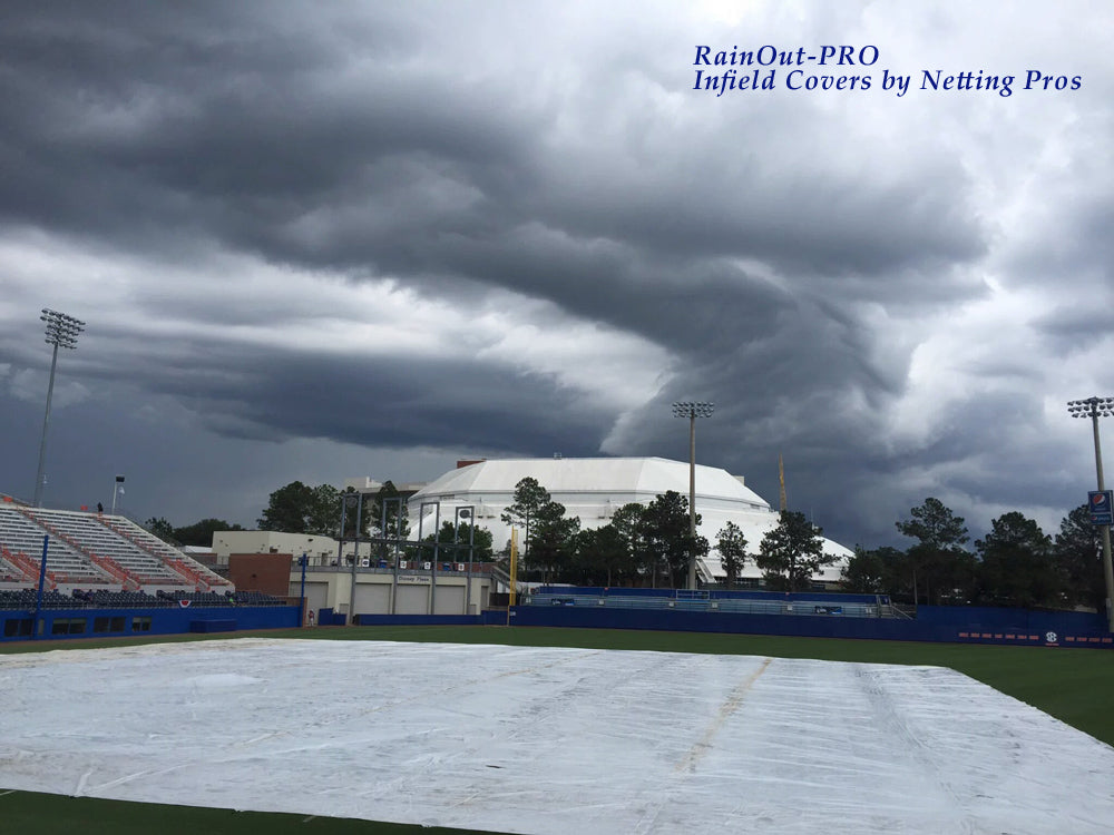 A baseball field with a cloudy sky above it.