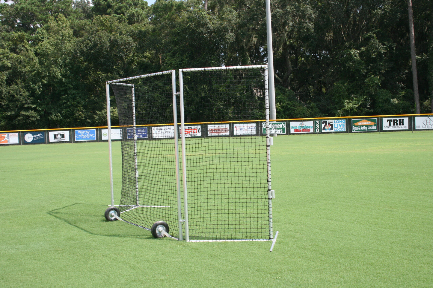 A soccer goal on the field with a net.