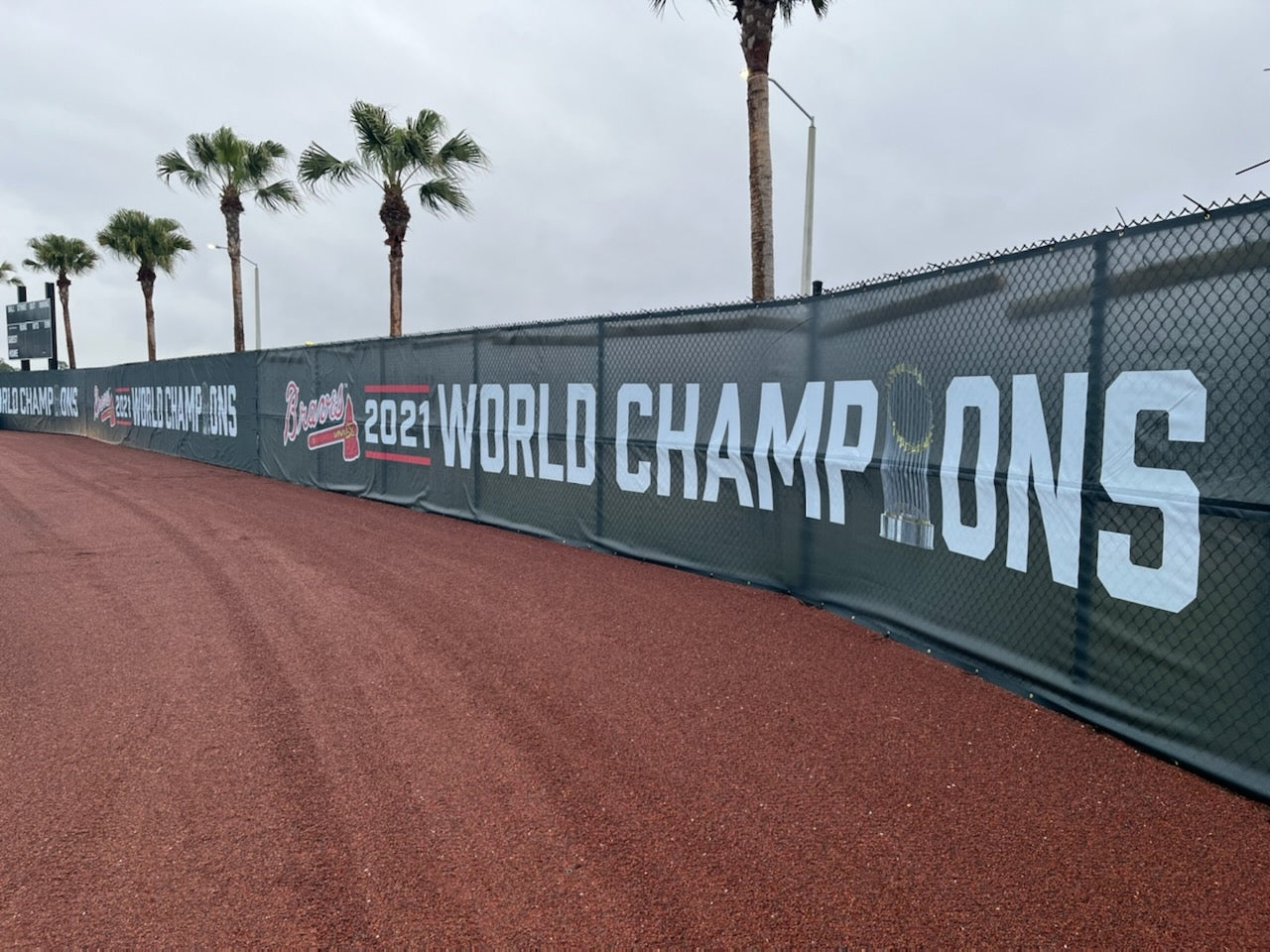 A fence that has been set up to protect the baseball field.